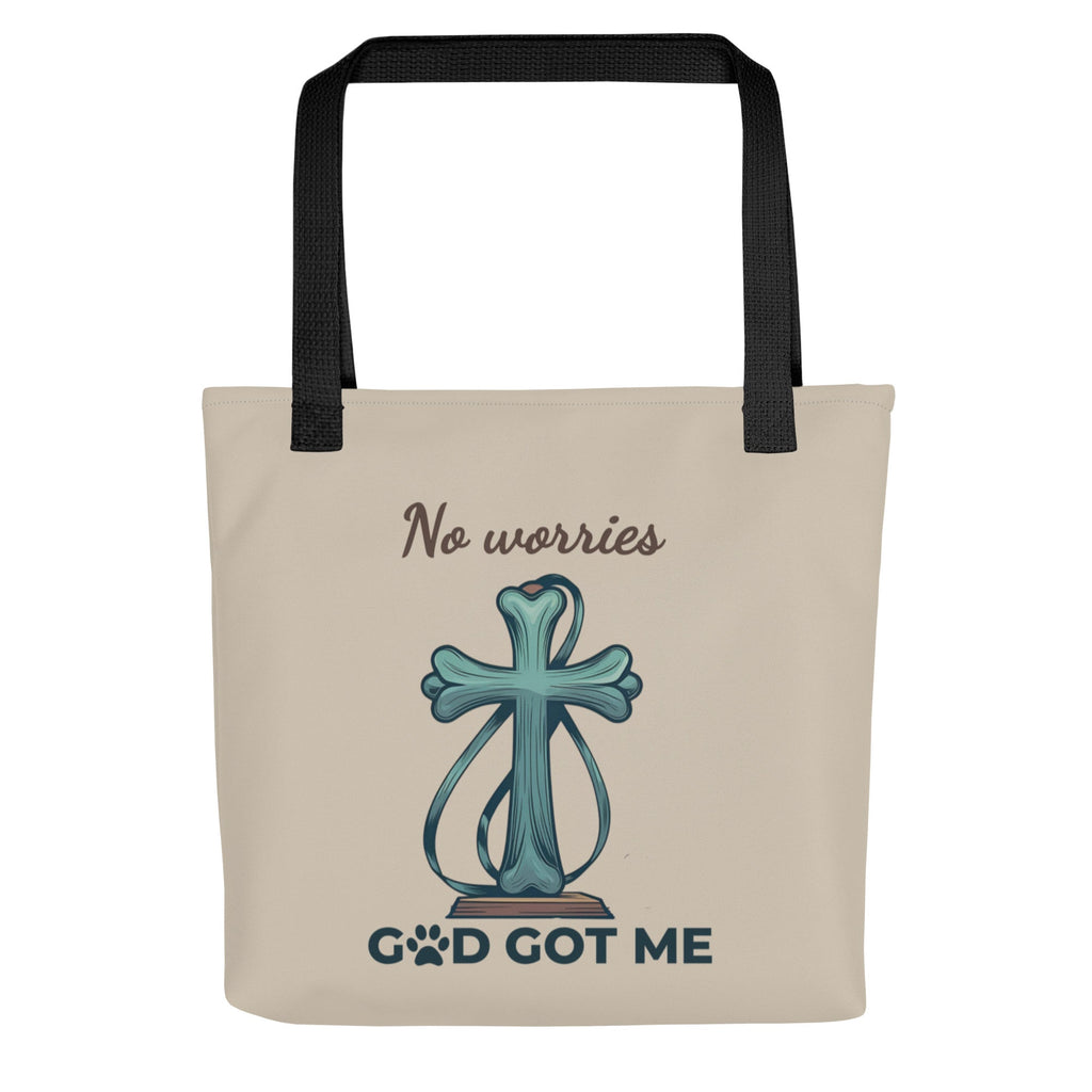 Front view of a taupe colored tote bag with the graphic image of cross with a dog leash wrapped around it with the words, "No worries, God got me"