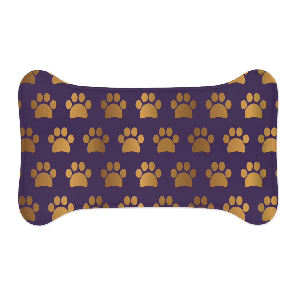 Bone‑shaped plush pet feeding mat in dark purple with gold heart‑of‑paw‑prints graphic 