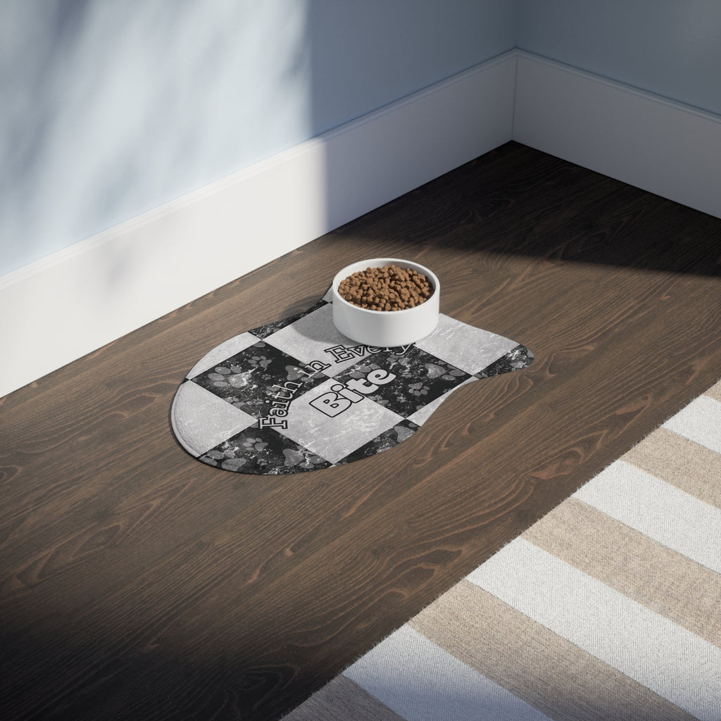 Fish‑shaped plush pet feeding mat in black and white checkerboard paw print design, featuring the phrase “Faith in Every Bite”.