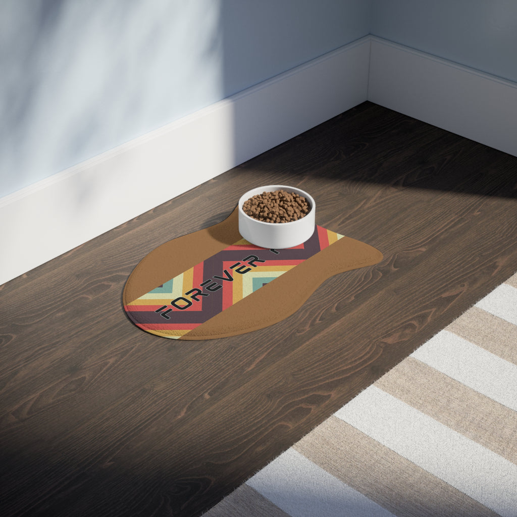 Pet feeding station with food and water bowls on caramel colored “Forever Fed” mat with retro stripes, placed on hardwood floor.
