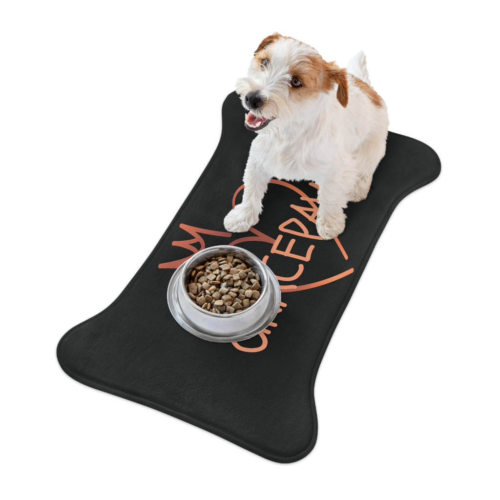 Black bone-shaped pet feeding mat with a heart and crown graphic and the word “GRACEPAW” in peach lettering, designed for comfort and non-slip functionality. The dog is on top of feeding mat with a pet bowl.