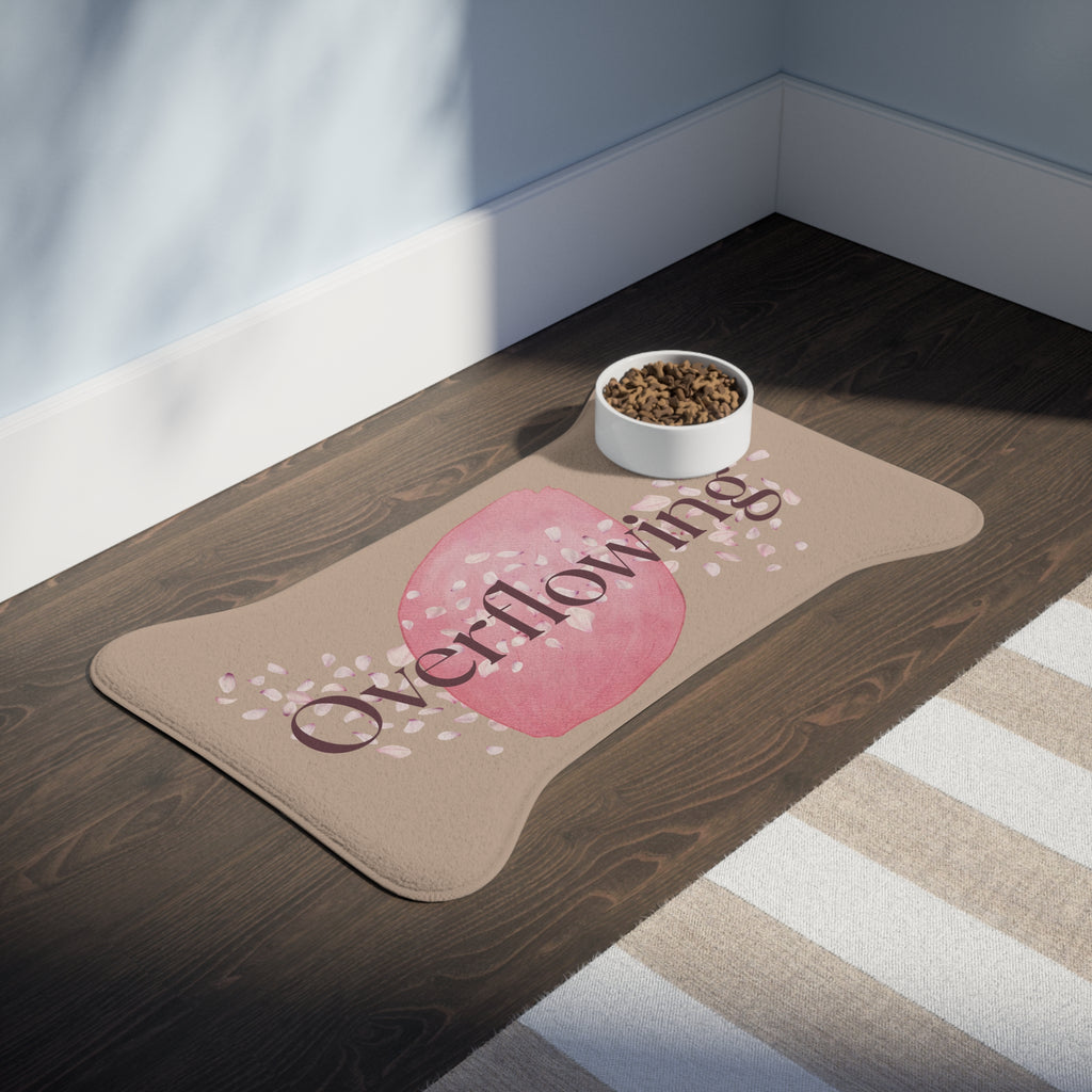 Rose petal designed “Overflowing” pet feeding mat with bowl of kibble in a sunlit kitchen corner