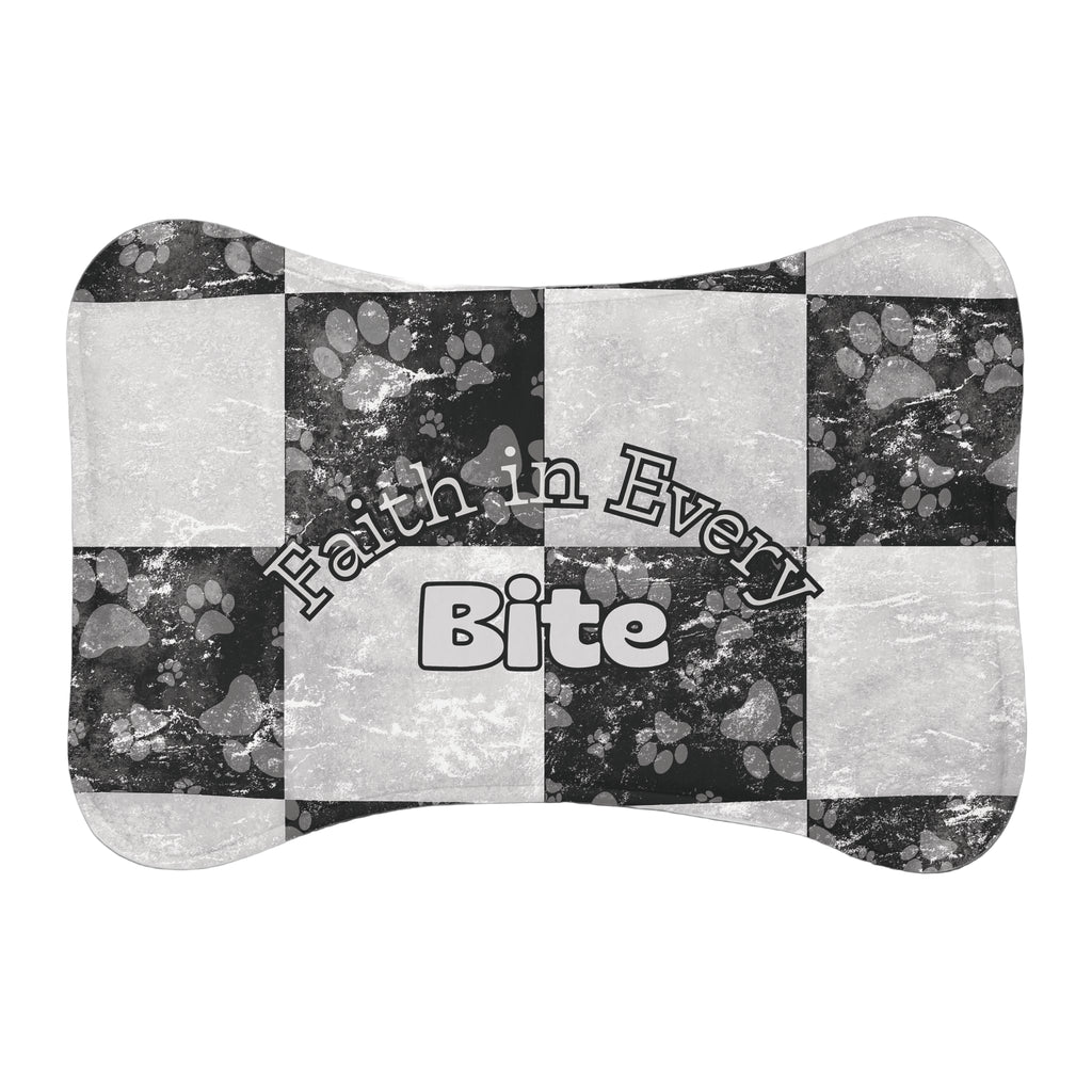 Bone‑shaped plush pet feeding mat in black and white checkerboard paw print design, featuring the phrase “Faith in Every Bite”.