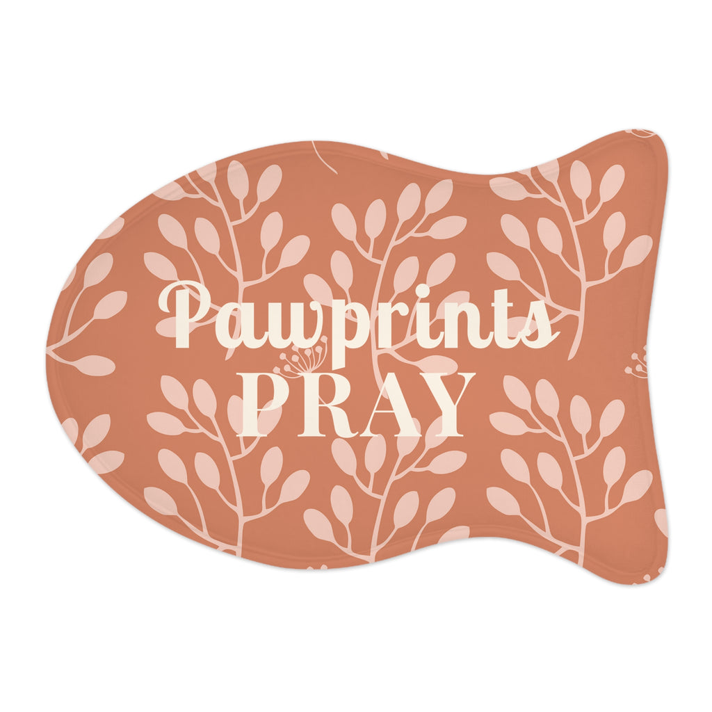 Flat view of fish-shaped pet feeding mat with terracotta background and light floral pattern.