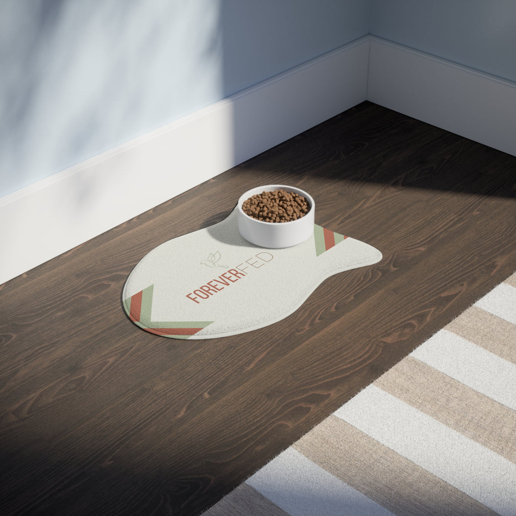 Fish-shaped plush pet feeding mat with cream background, geometric side patterns in muted sage and rust, and “Forever Fed” text with minimalist dove graphic in the center.