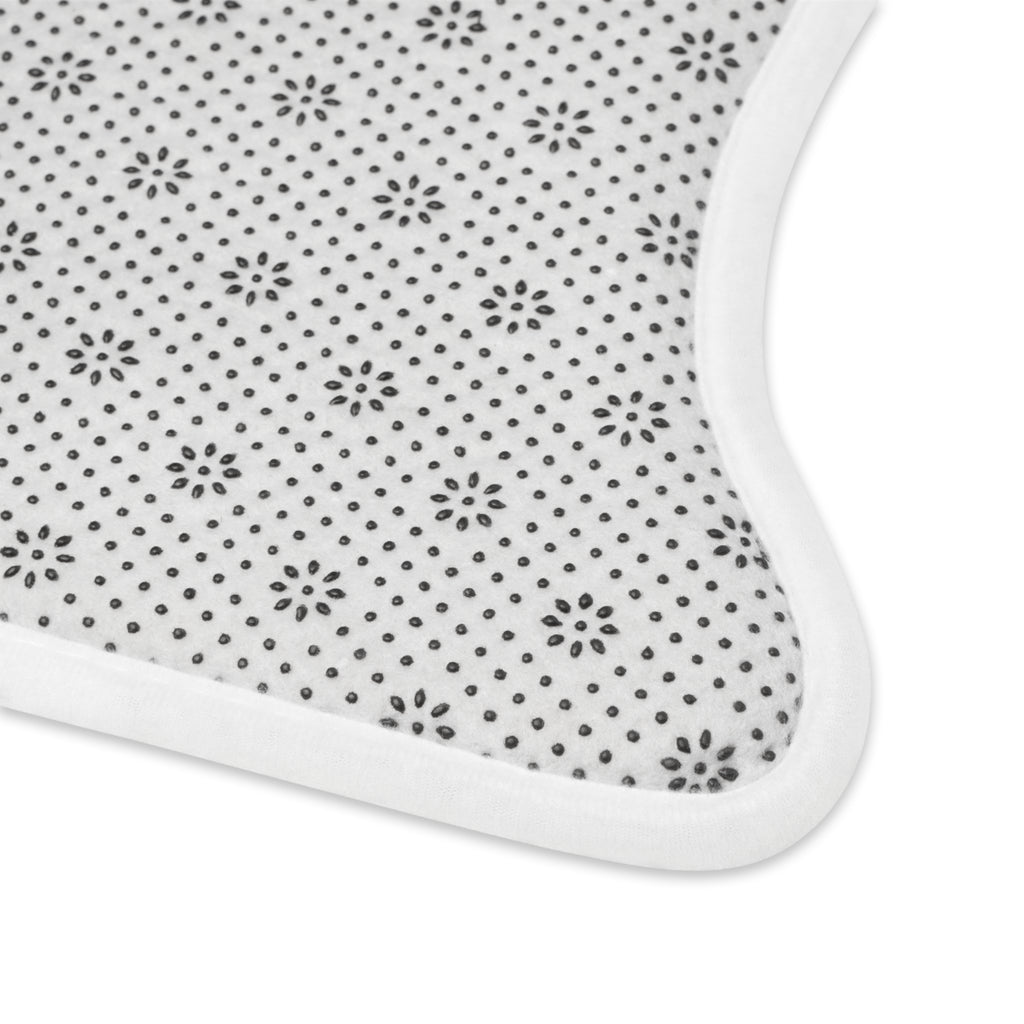Close-up of anti-slip rubber backing with floral grip pattern on underside of feeding mat.