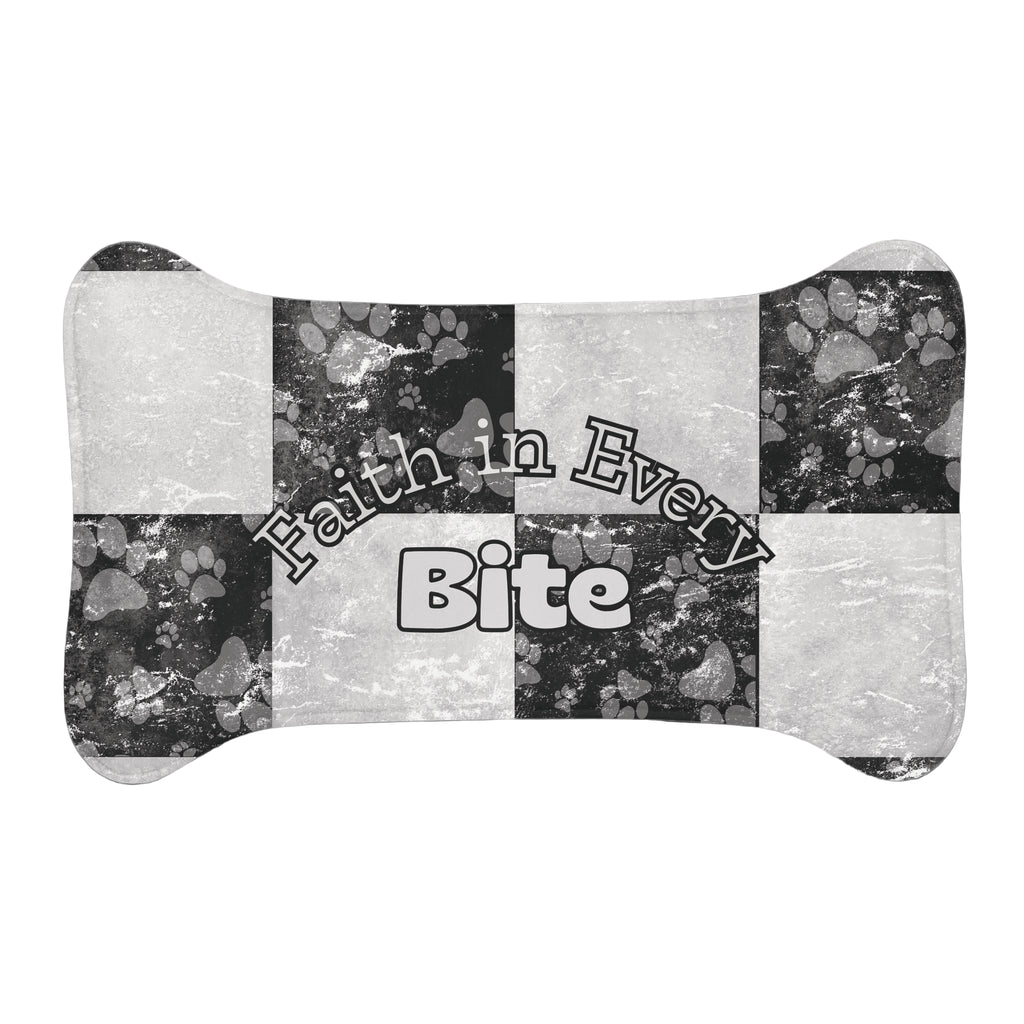 Bone‑shaped plush pet feeding mat in black and white checkerboard paw print design, featuring the phrase “Faith in Every Bite”.