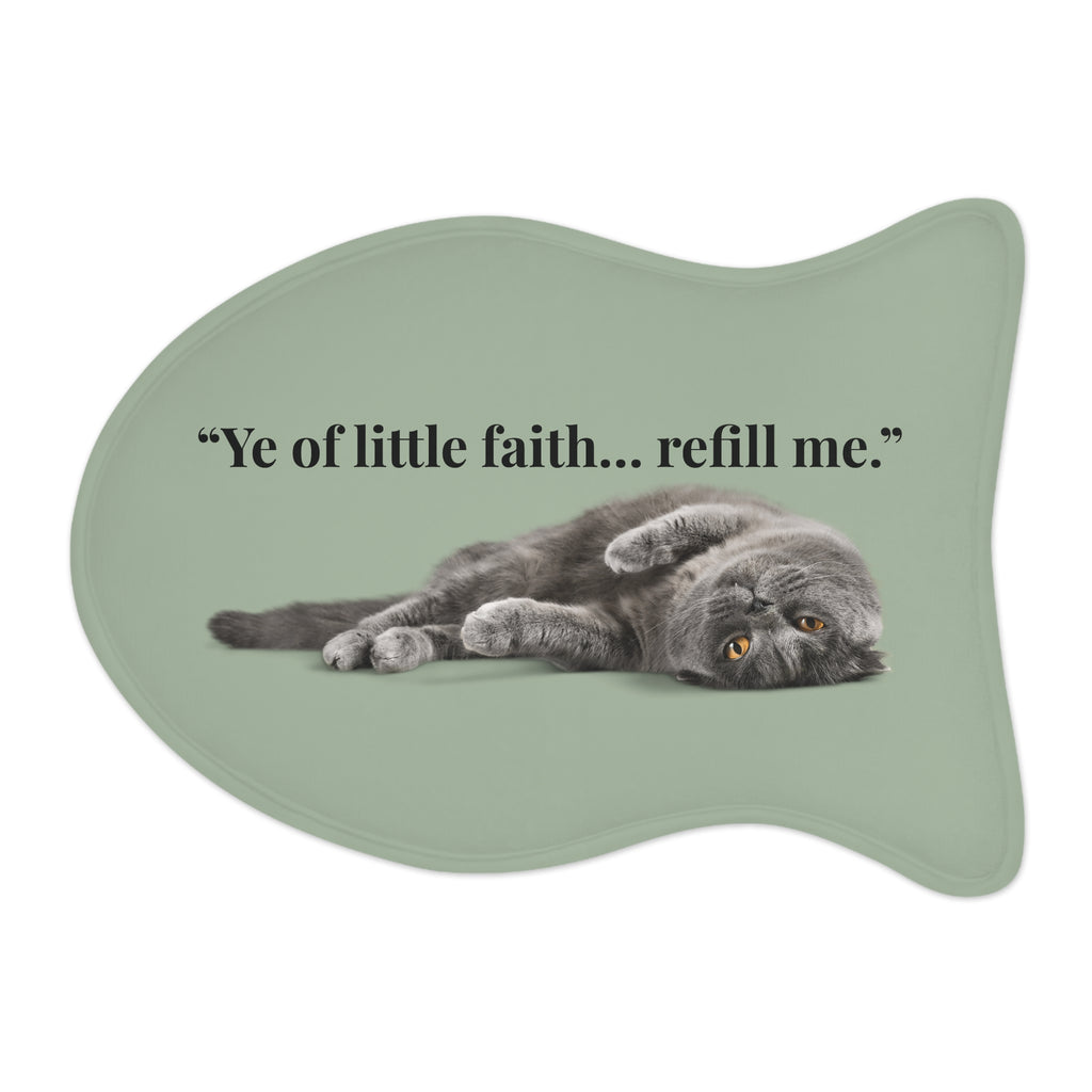 Fish‑shaped plush pet feeding mat in sage green with grey cat image and text “Ye of little faith… refill me.” across the center.