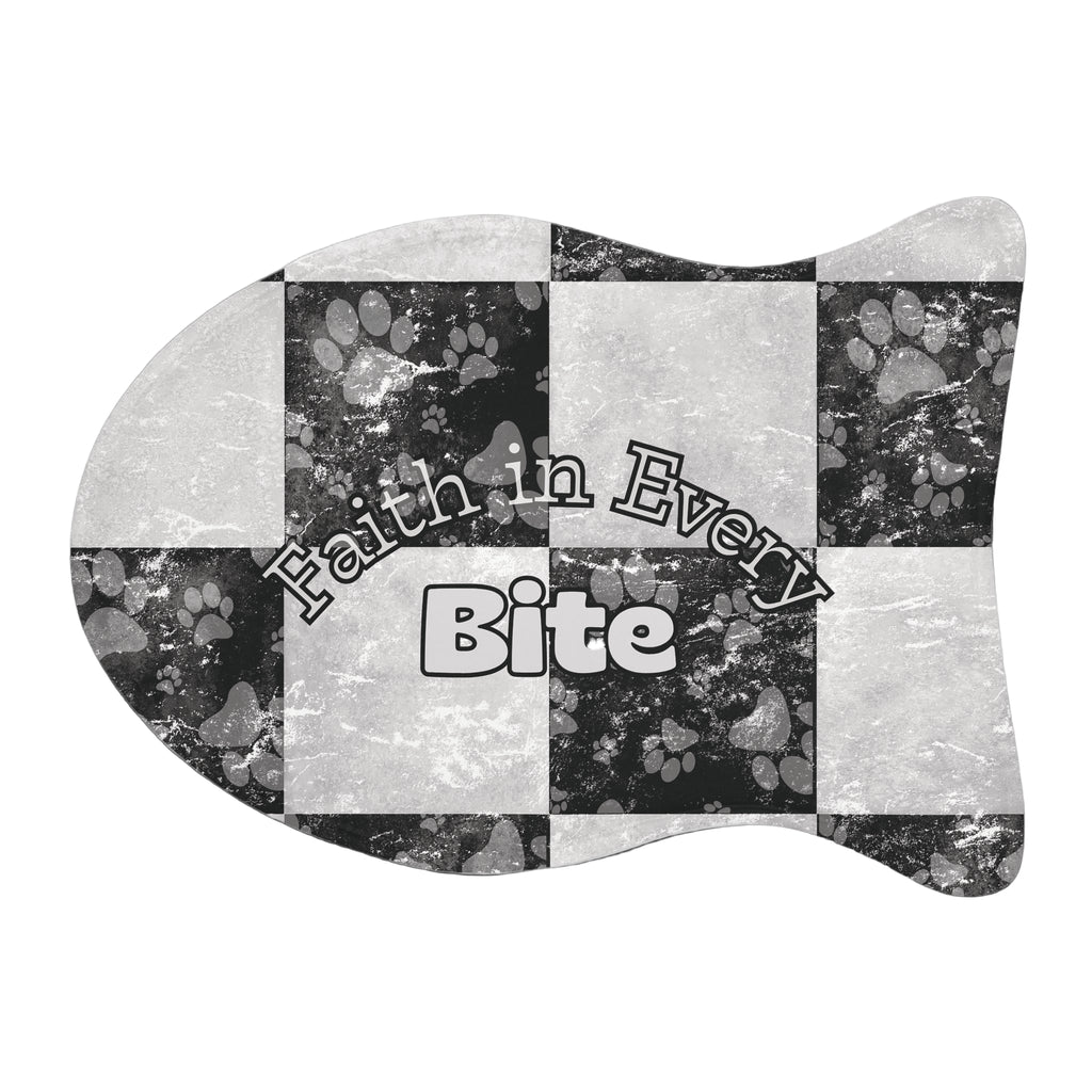 Fish‑shaped plush pet feeding mat in black and white checkerboard paw print design, featuring the phrase “Faith in Every Bite”.