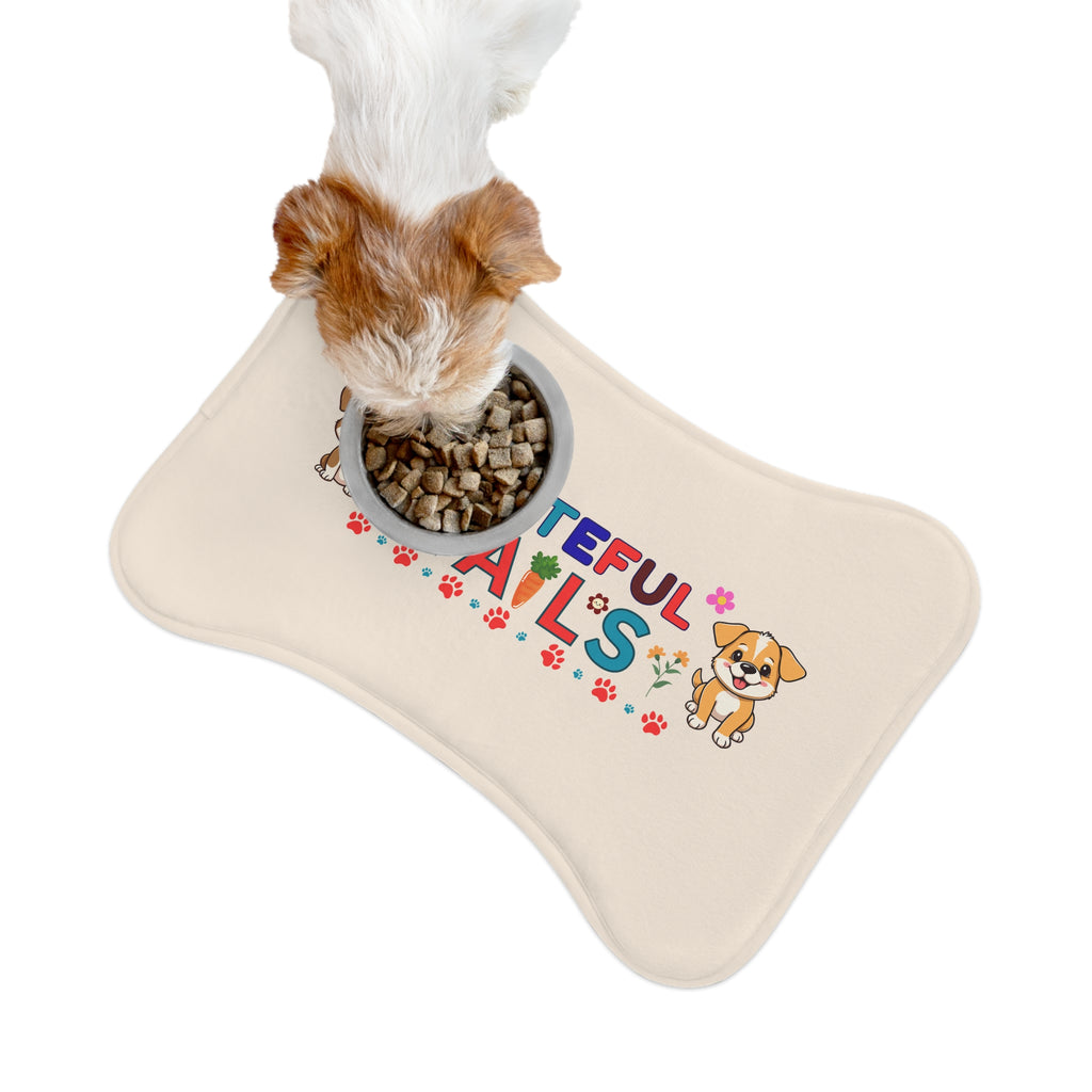 Small dog eating kibble from bowl placed on cream “Grateful Tails” pet feeding mat.