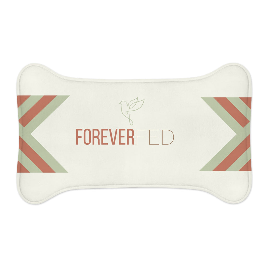 Bone-shaped plush pet feeding mat with cream background, geometric side patterns in muted sage and rust, and “Forever Fed” text with minimalist dove graphic in the center.