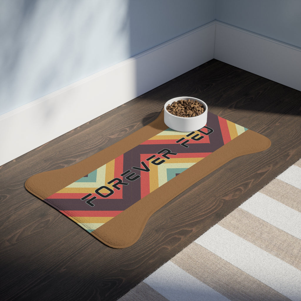 Pet feeding station with food and water bowls on caramel colored “Forever Fed” mat with retro stripes, placed on hardwood floor.