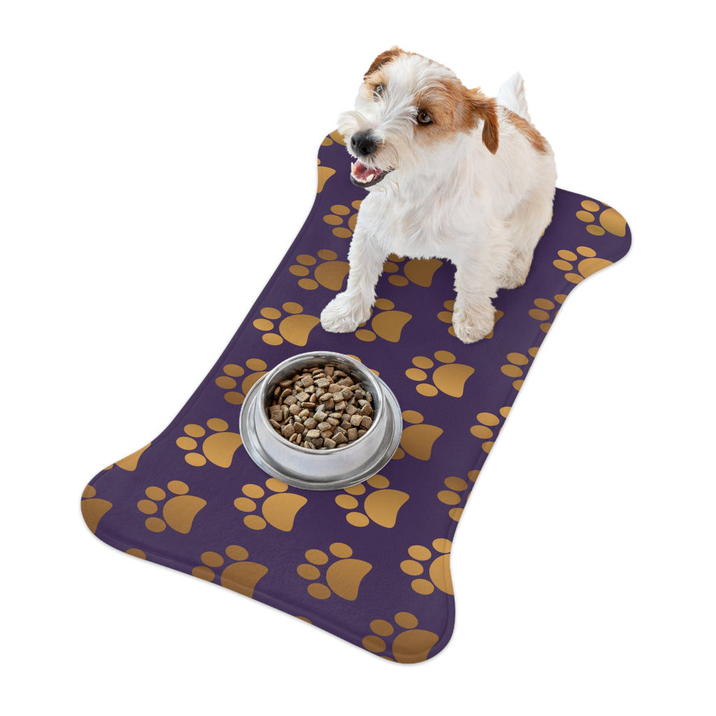 Bone‑shaped plush pet feeding mat in dark purple with gold heart‑of‑paw‑prints graphic 