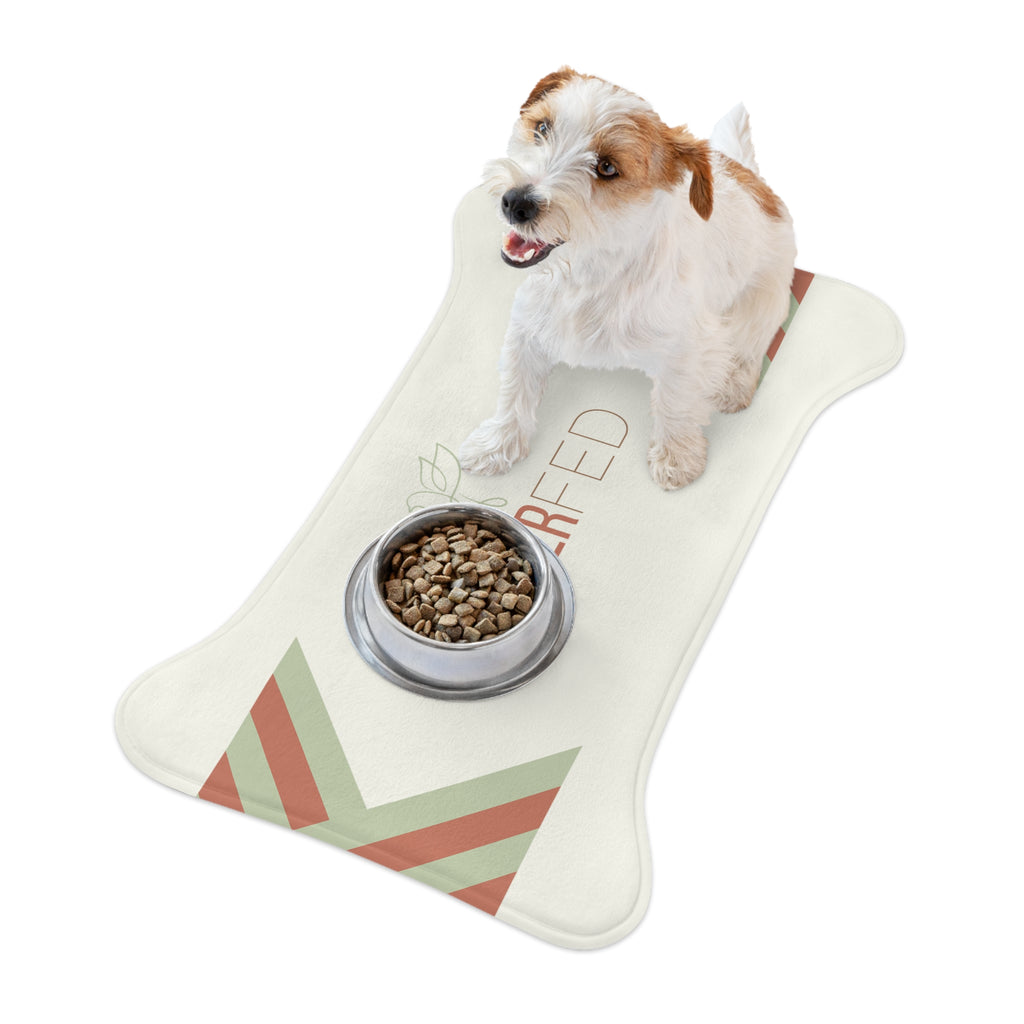 Bone-shaped plush pet feeding mat with cream background, geometric side patterns in muted sage and rust, and “Forever Fed” text with minimalist dove graphic in the center.
