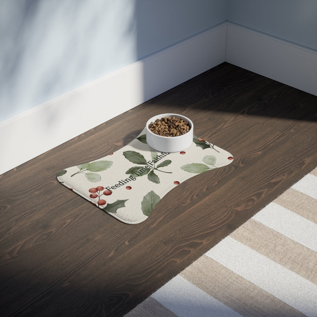 Bone‑shaped plush pet feeding mat in dark purple with gold heart‑of‑paw‑prints graphic and text “Risen Love Renewed Paw”