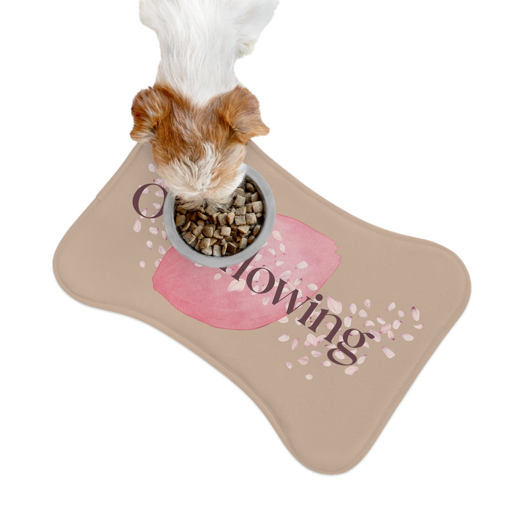 Small dog eating kibble from a bowl placed on rose petal designed “Overflowing” pet feeding mat