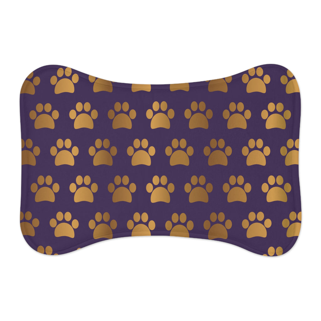 Bone‑shaped plush pet feeding mat in dark purple with gold heart‑of‑paw‑prints graphic 