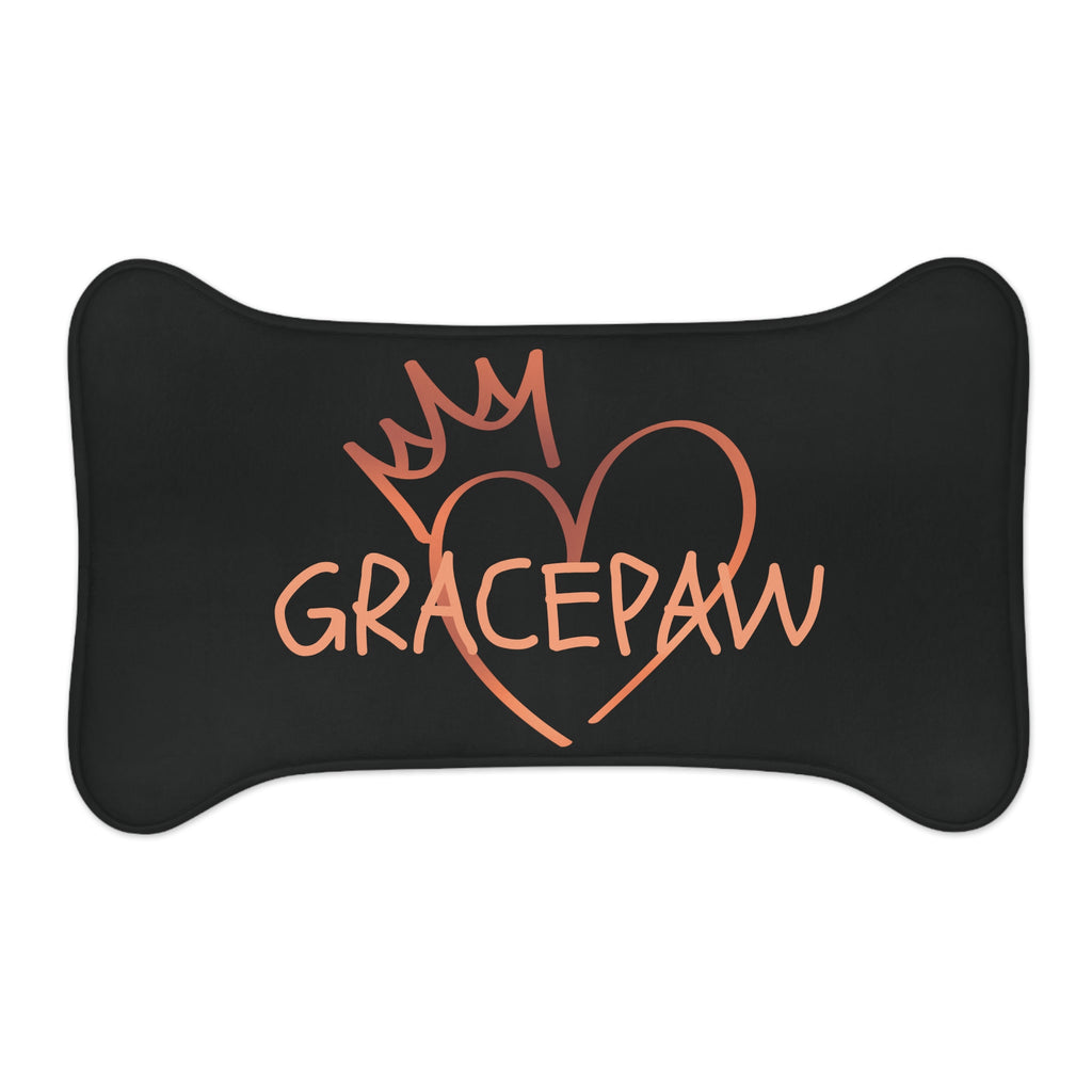 Black bone-shaped pet feeding mat with a heart and crown graphic and the word “GRACEPAW” in peach lettering, designed for comfort and non-slip functionality.