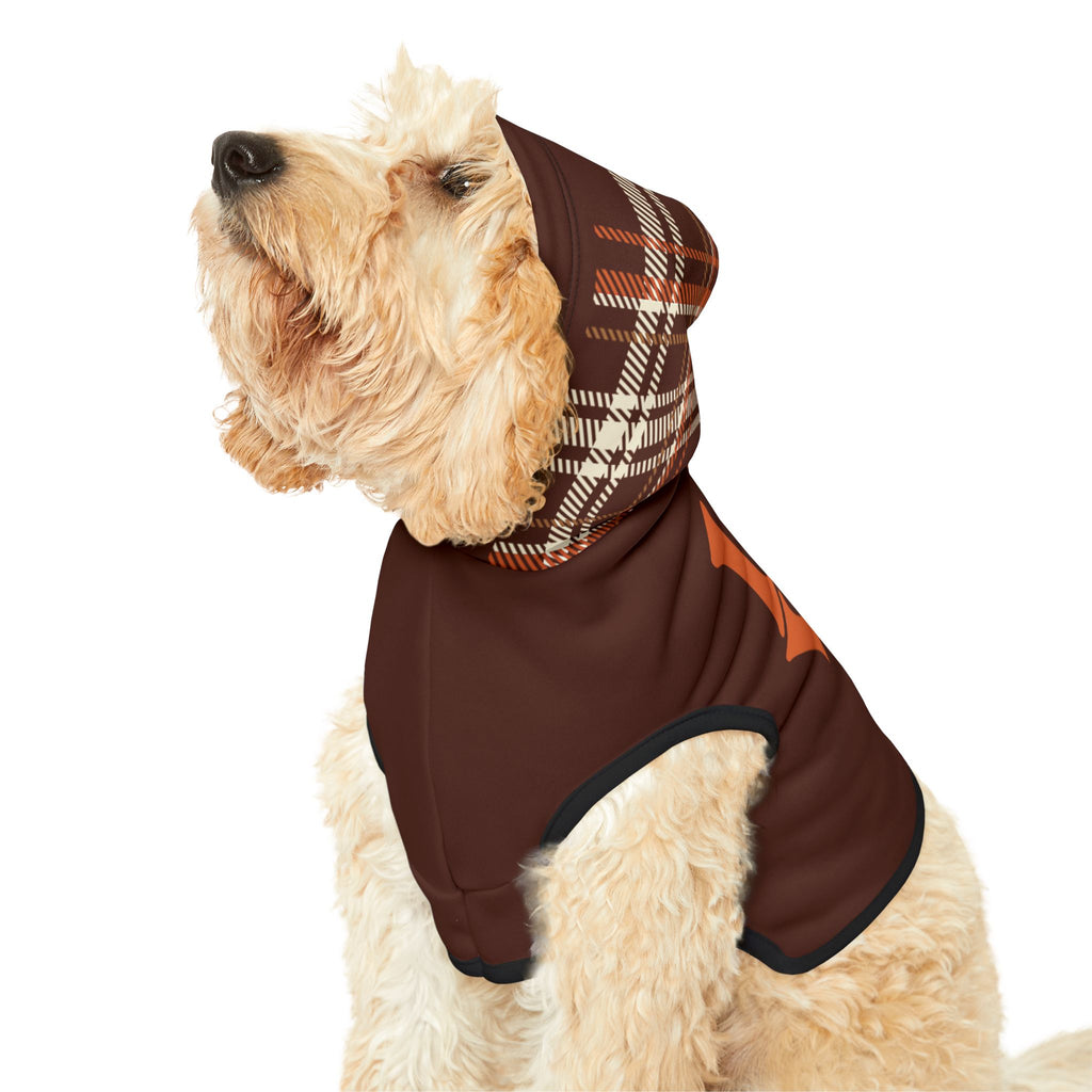 Light-colored dog wearing brown hoodie with plaid hood pulled over head, showing side profile.