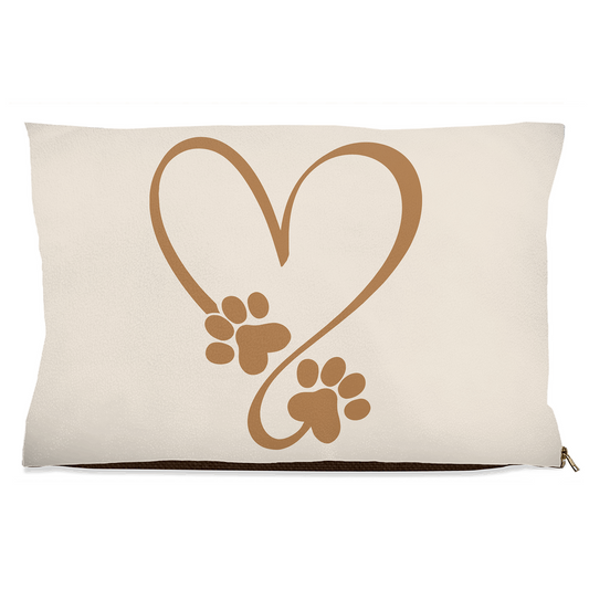Beige pillow with brown heart and paw prints design on a white background