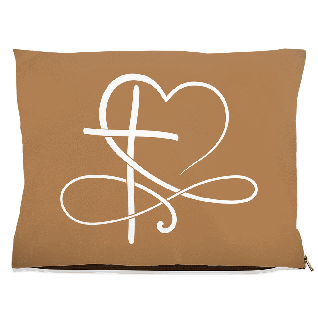 Tan pet pillow with a white heart and cross design on a white background