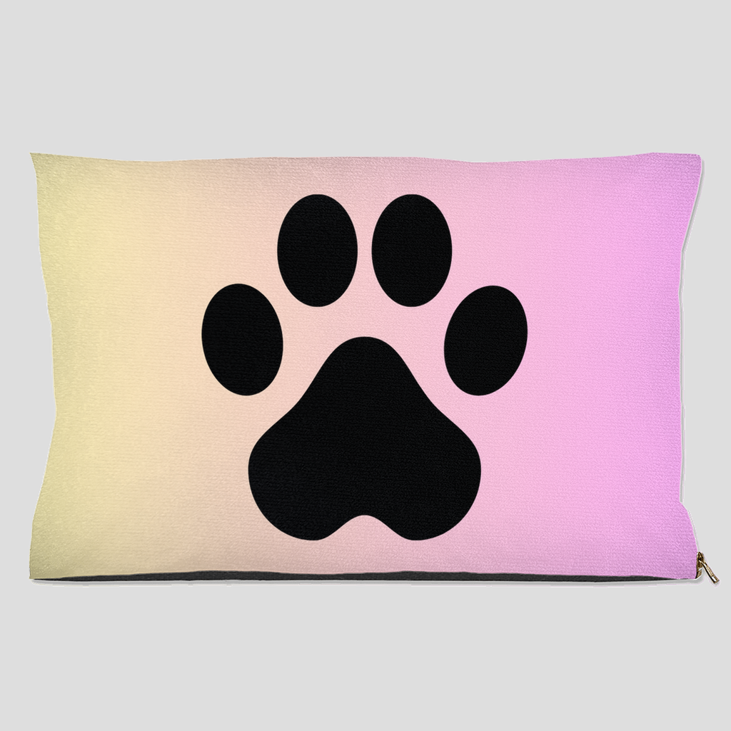 Pet bed with black paw print on pastel cream to pink gradient background