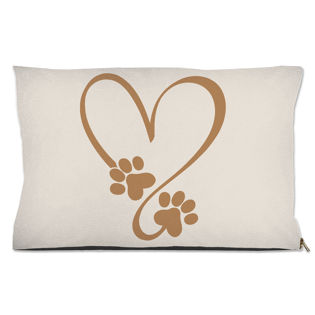 Beige pillow with a brown heart design made of paw prints on a white background