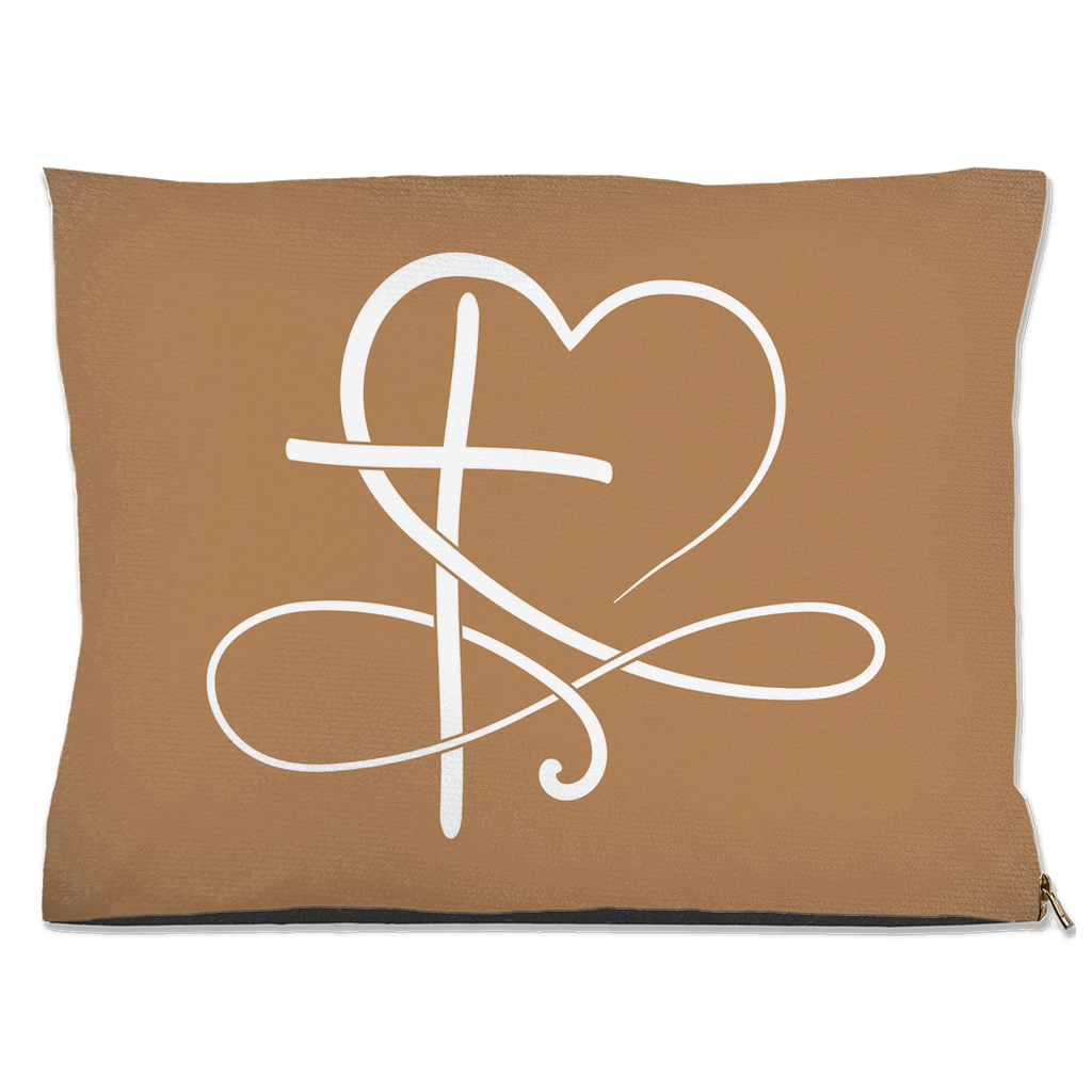 Tan pet pillow with a white heart and cross design on a white background