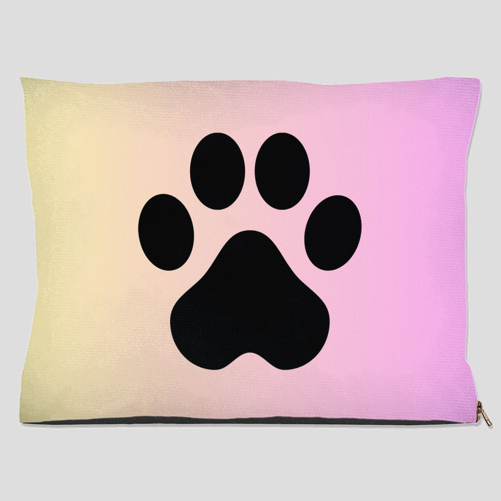 Pet bed with black paw print on pastel cream to pink gradient background