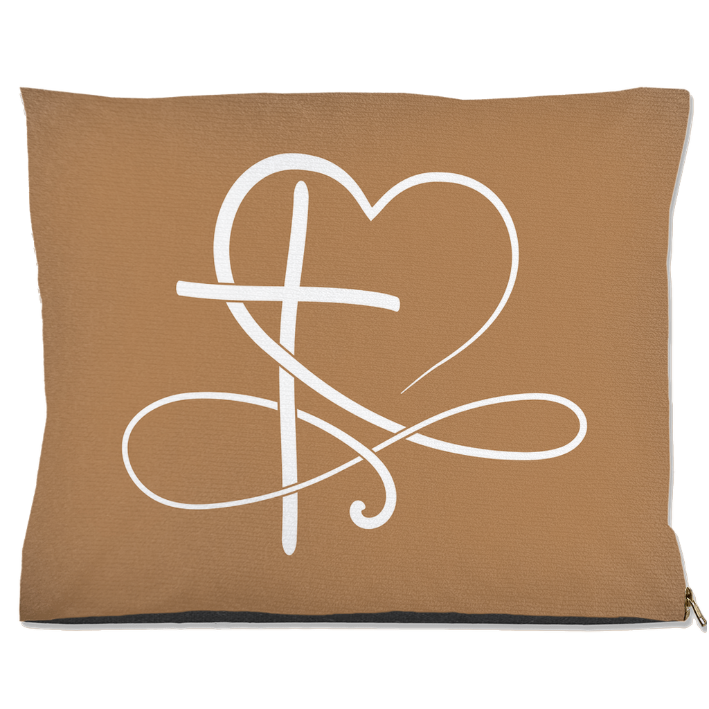 Tan pet pillow with a white heart and cross design on a white background