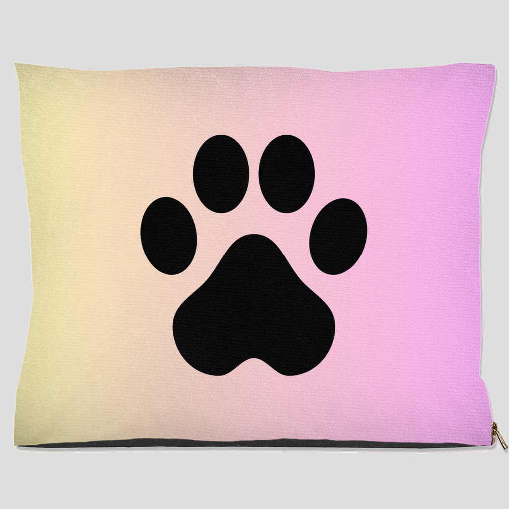 Pet bed with black paw print on pastel cream to pink gradient background