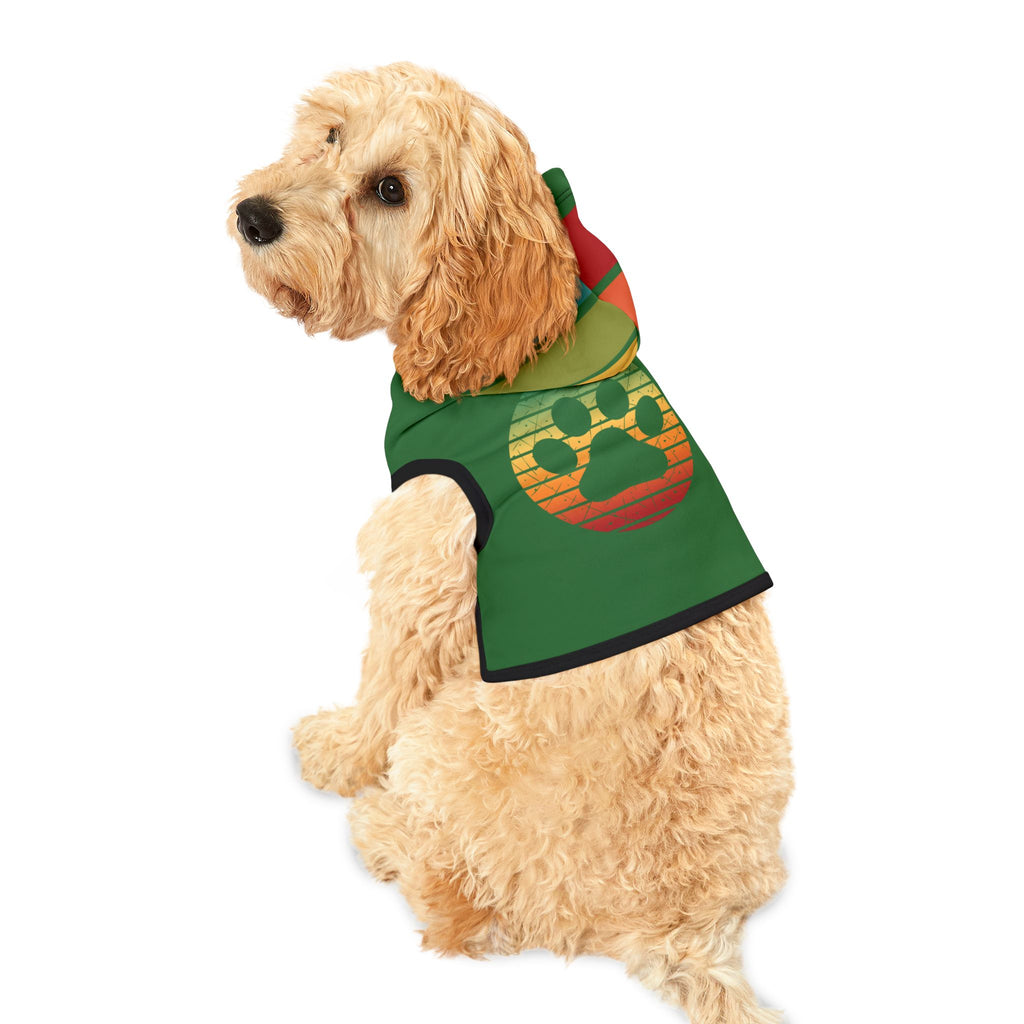 Fluffy light tan dog wearing the green dog hoodie, turned to the side to display the rainbow-striped paw print graphic on the back and the multi-color hood.