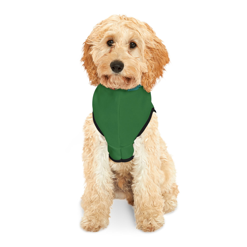 Fluffy light tan dog wearing the green dog hoodie, facing forward, showing the solid green front and black trim.
