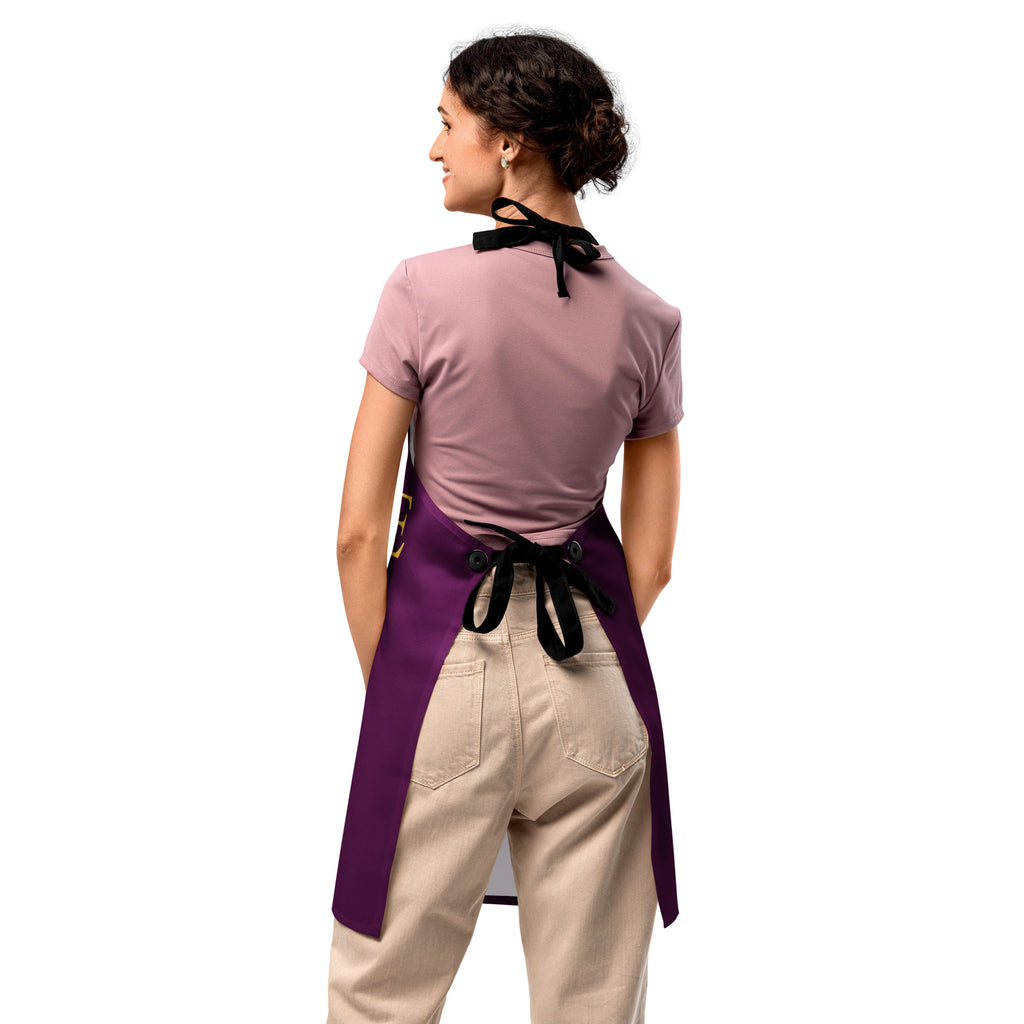 Purple apron featuring the word “LOVE” in gold lettering, with a golden paw print replacing the “O,” symbolizing love for pets and faith in a sleek, elegant design.