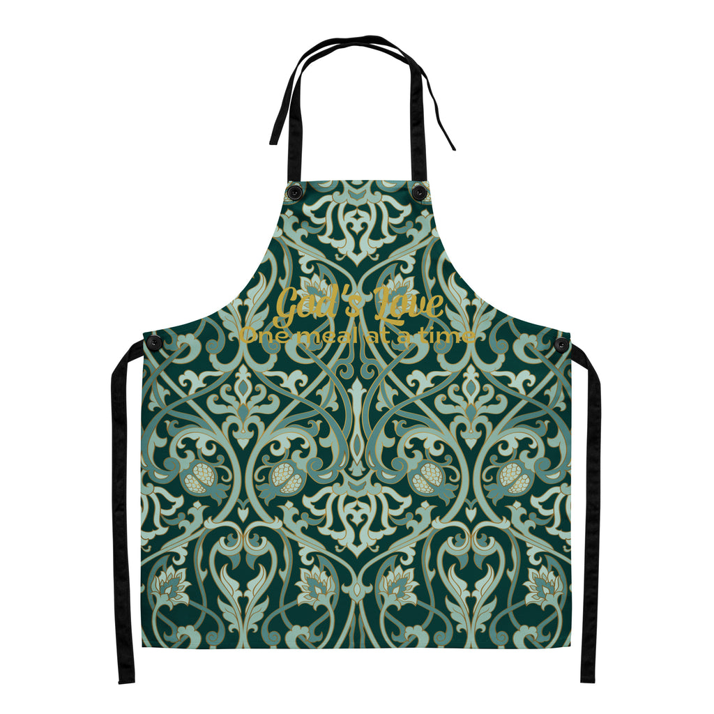 Faith-inspired apron with ornate sage and emerald baroque-style floral pattern, featuring the phrase “God’s Love  One Meal at a Time” in elegant gold lettering across the chest.