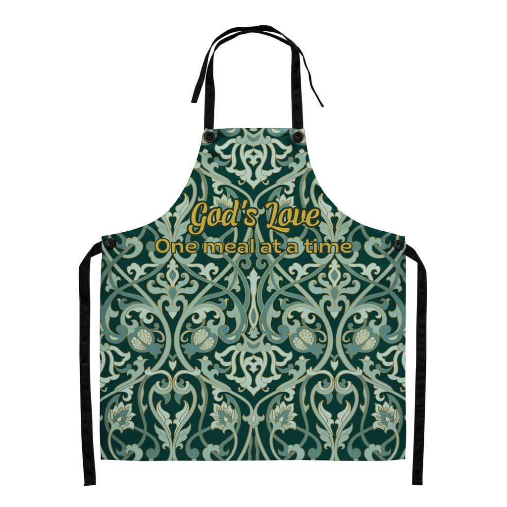 Faith-inspired apron with ornate sage and emerald baroque-style floral pattern, featuring the phrase “God’s Love  One Meal at a Time” in elegant gold lettering across the chest.