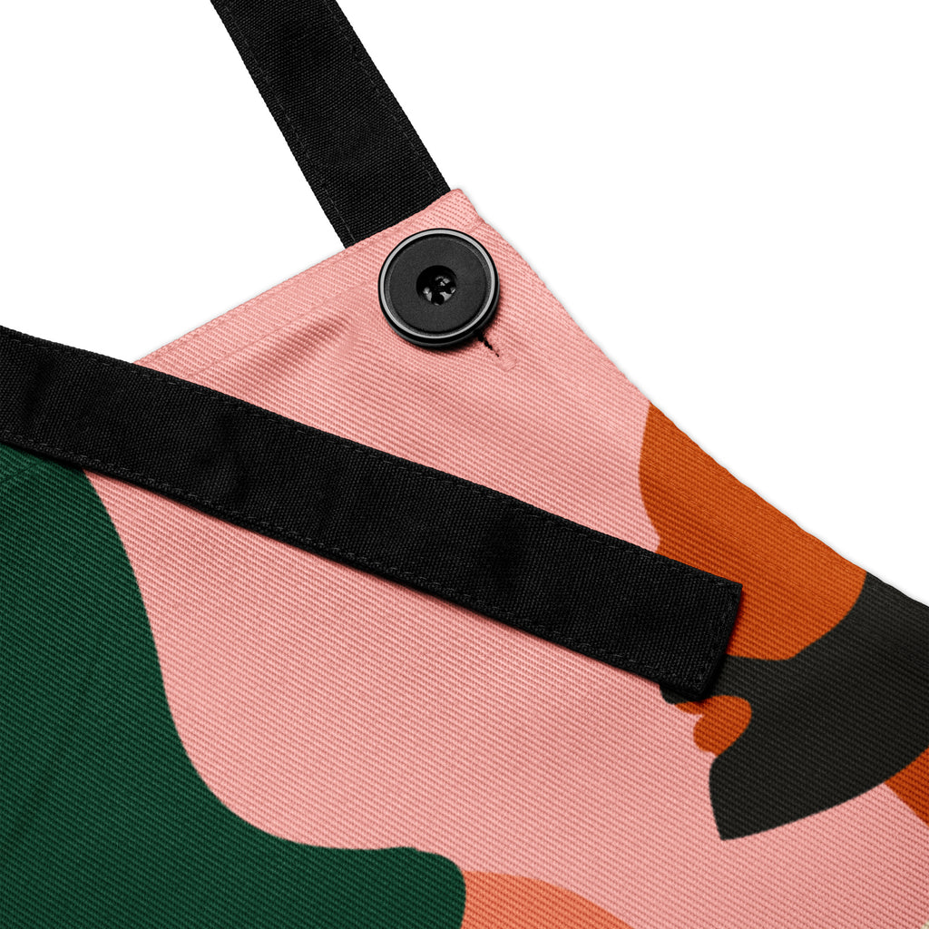 Faith Feeds the Soul apron featuring colorful, abstract silhouettes of diverse people in warm earthy tones — green, terracotta, blush, blue, and cream — with black text that reads “Faith feeds the soul.”
