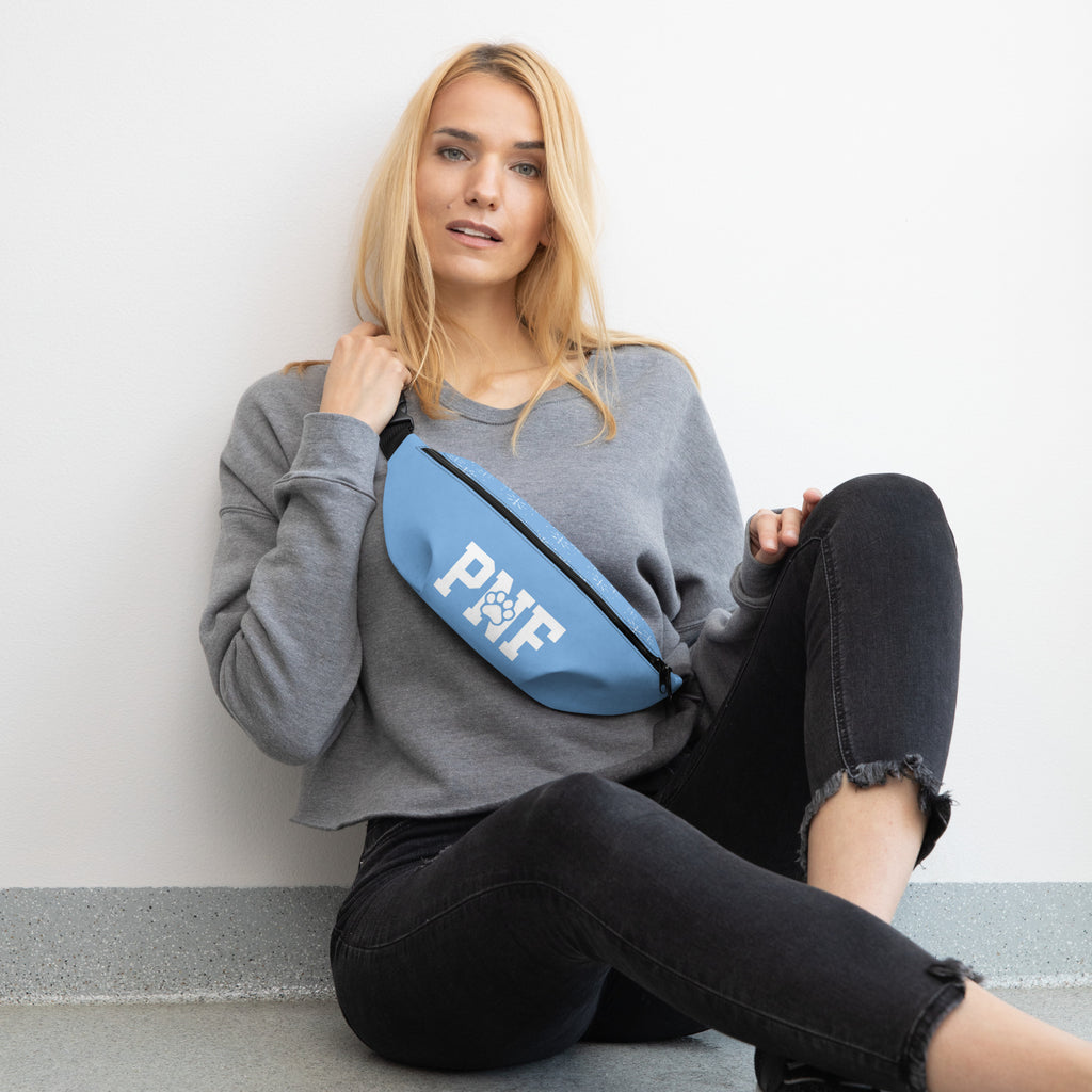 Light blue Pets N’ Faith fanny pack with bold white PNF letters and paw print logo on the front.