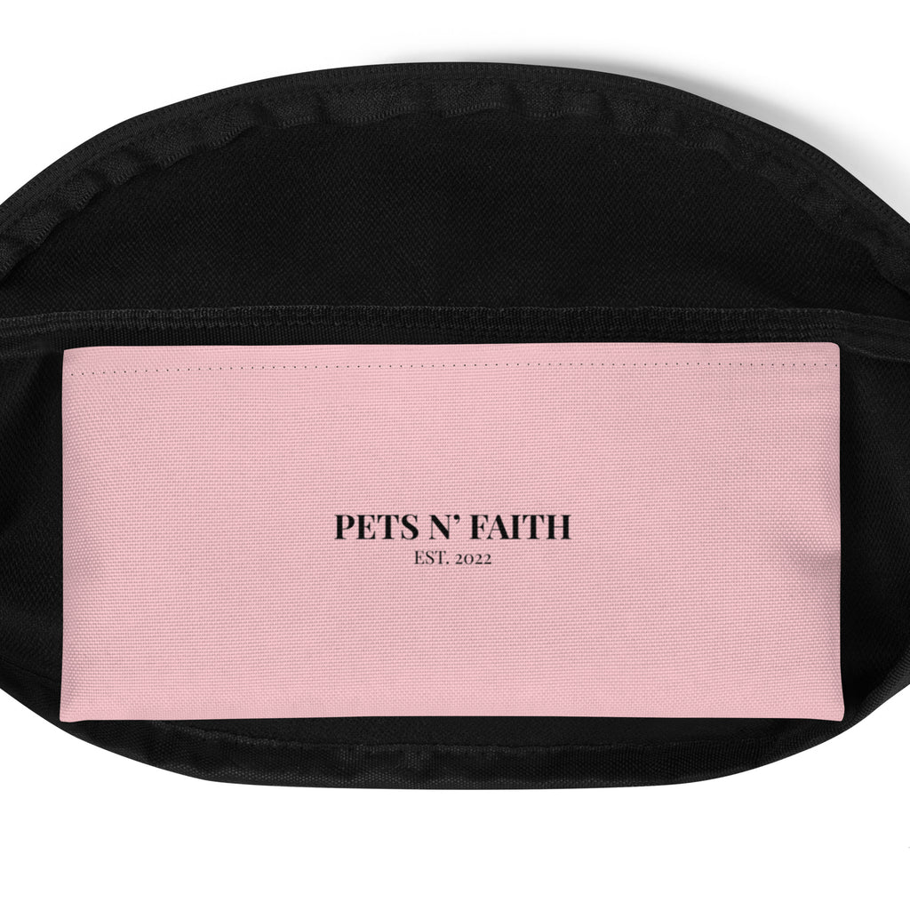 Pink fanny pack featuring the word ‘Jesus’ in black cursive with a leash-style design, faith-inspired accessory