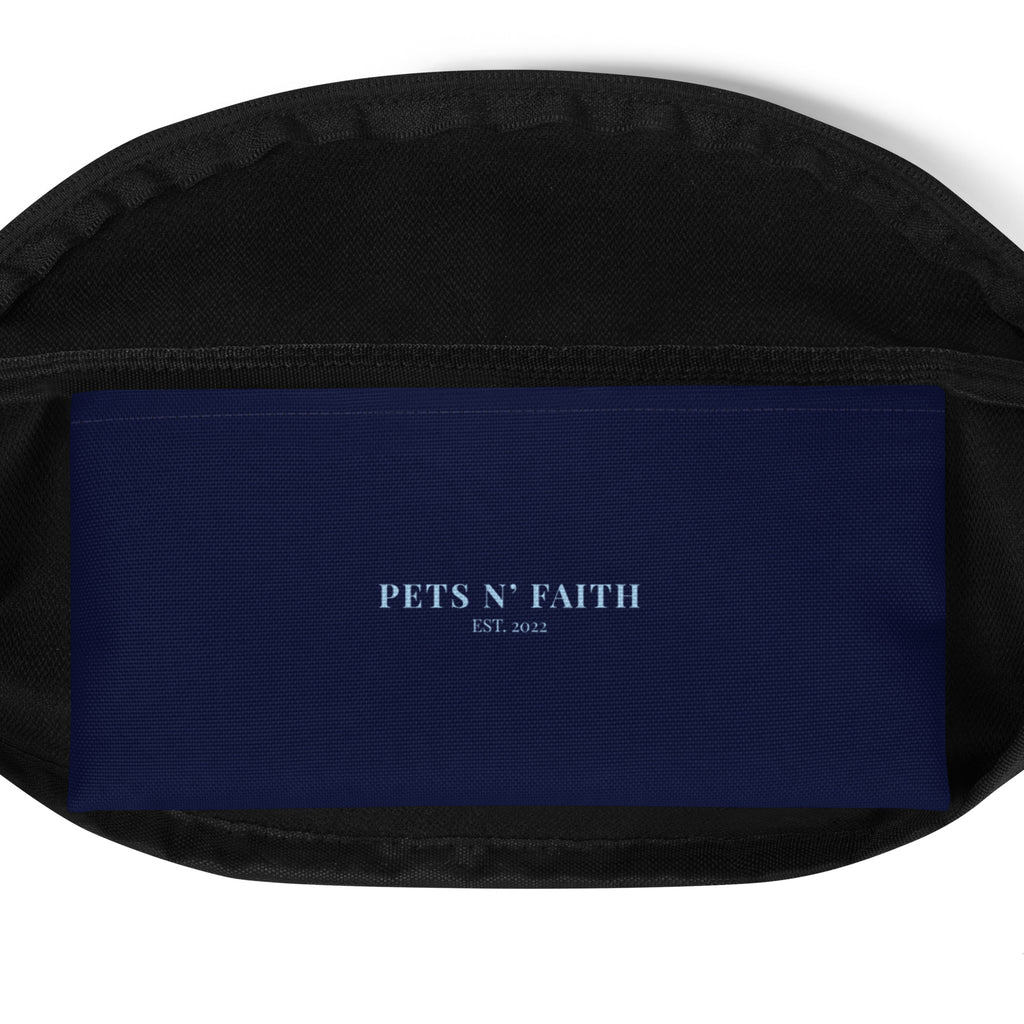 Inside view of navy blue fanny pack with the phrase “LEASHED BY LOVE, LED BY GRACE” in light blue letters, decorated with paw prints.