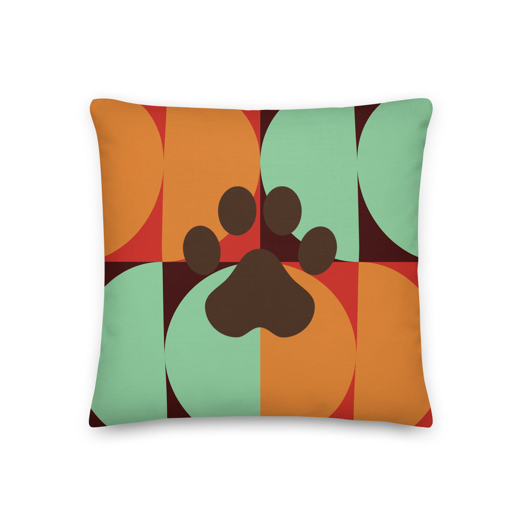 Multicolor retro-style pillow with bold geometric pattern in orange, teal, and red featuring a dark paw print in the center, Pets N’ Faith design