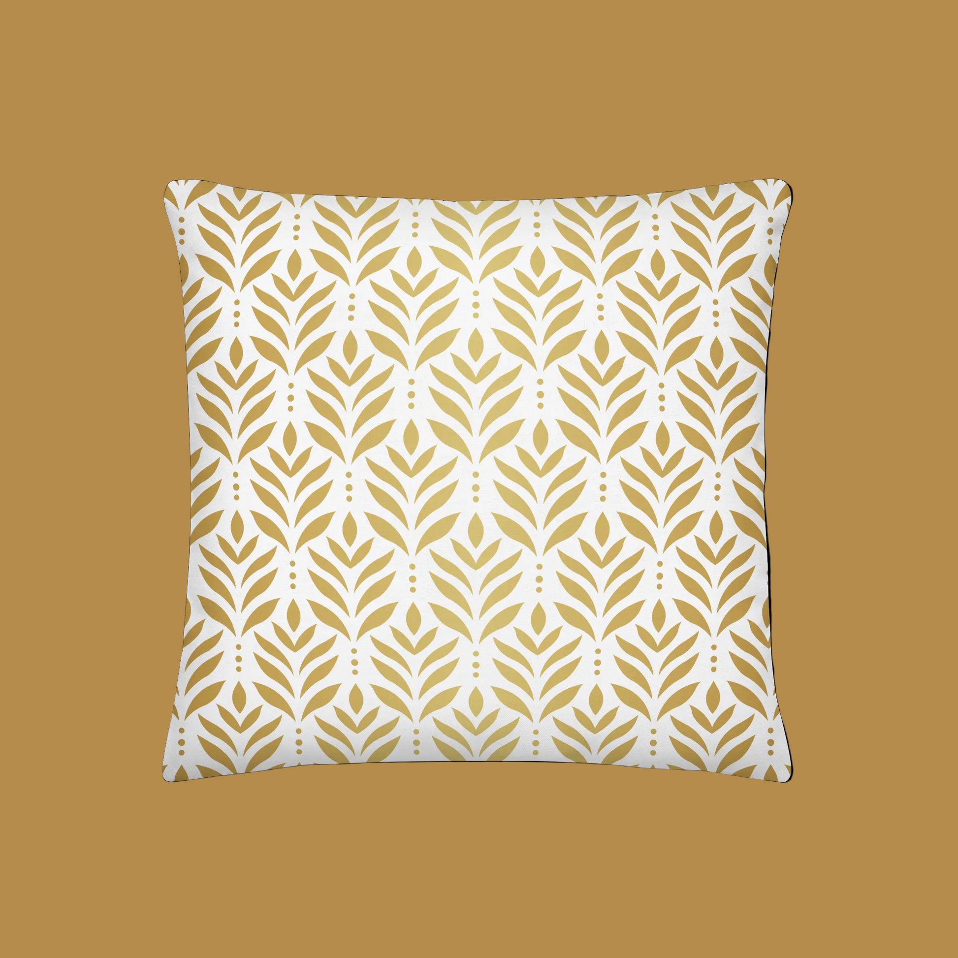 Decorative pillow with gold leaf pattern on a white background
