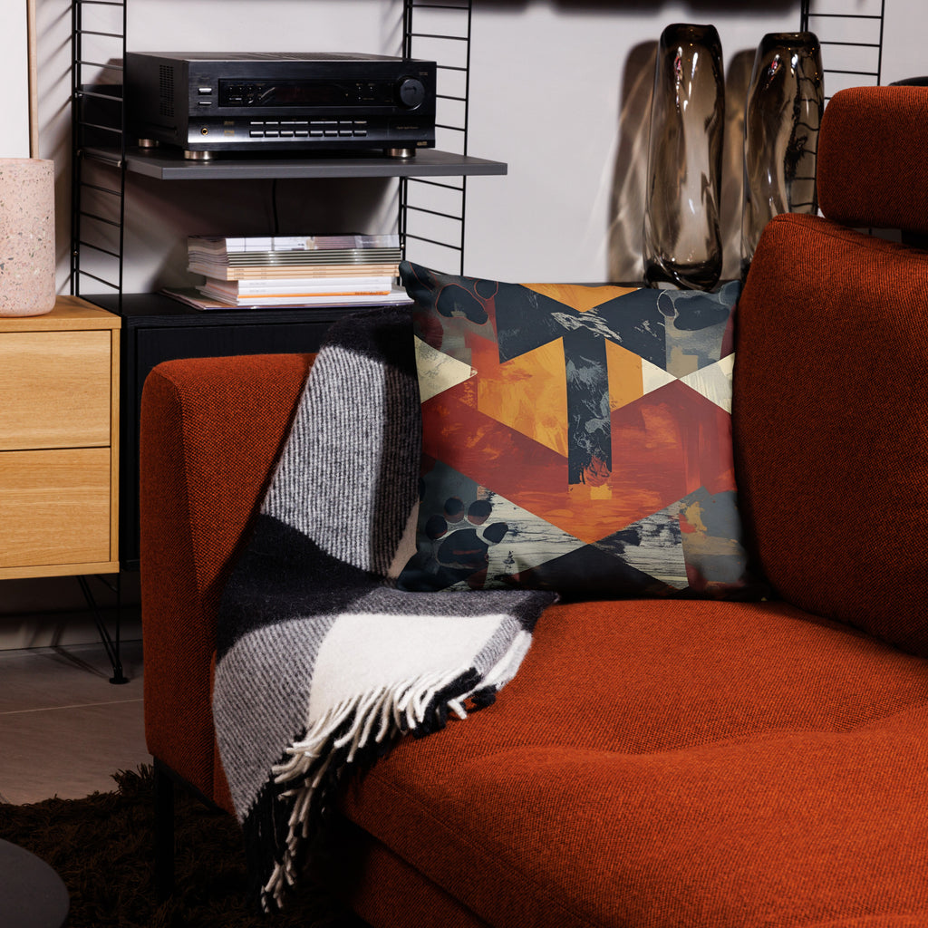 Front view of abstract geometric design pillow on red couch. 