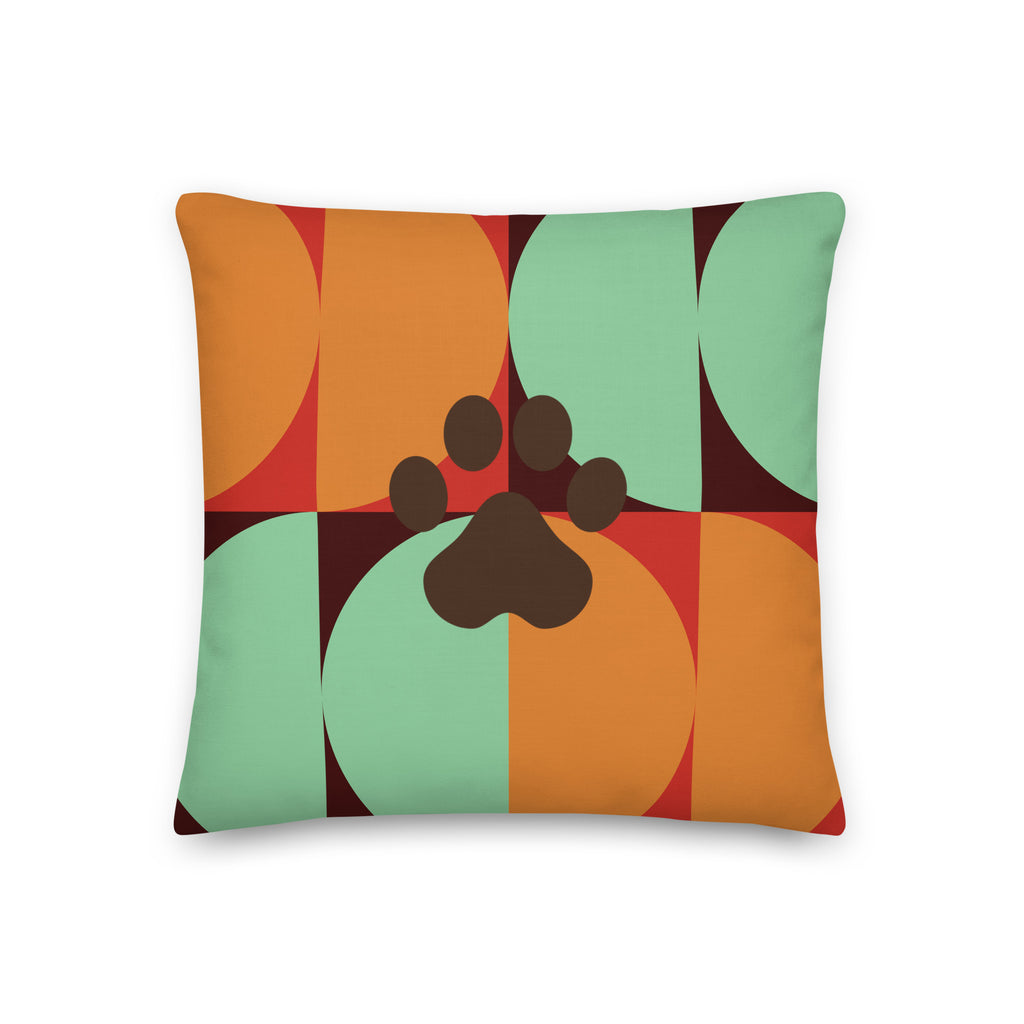 Multicolor retro-style pillow with bold geometric pattern in orange, teal, and red featuring a dark paw print in the center, Pets N’ Faith design