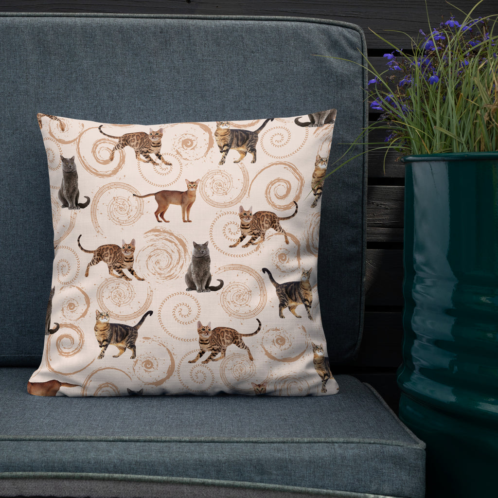 Cream accent pillow featuring illustrated cats in gray, brown, and tabby patterns surrounded by spiral swirls, luxury cat lover home décor by Pets N’ Faith.