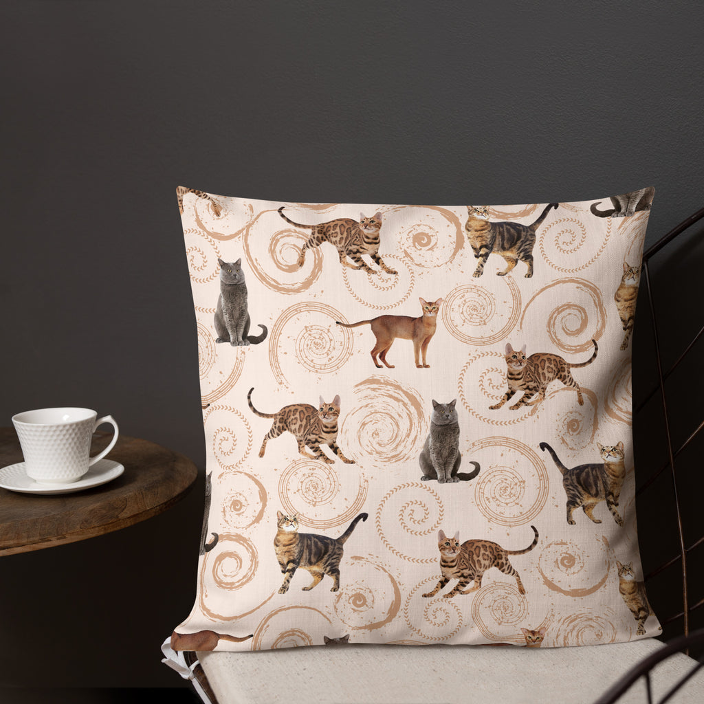 Cream accent pillow featuring illustrated cats in gray, brown, and tabby patterns surrounded by spiral swirls, luxury cat lover home décor by Pets N’ Faith.