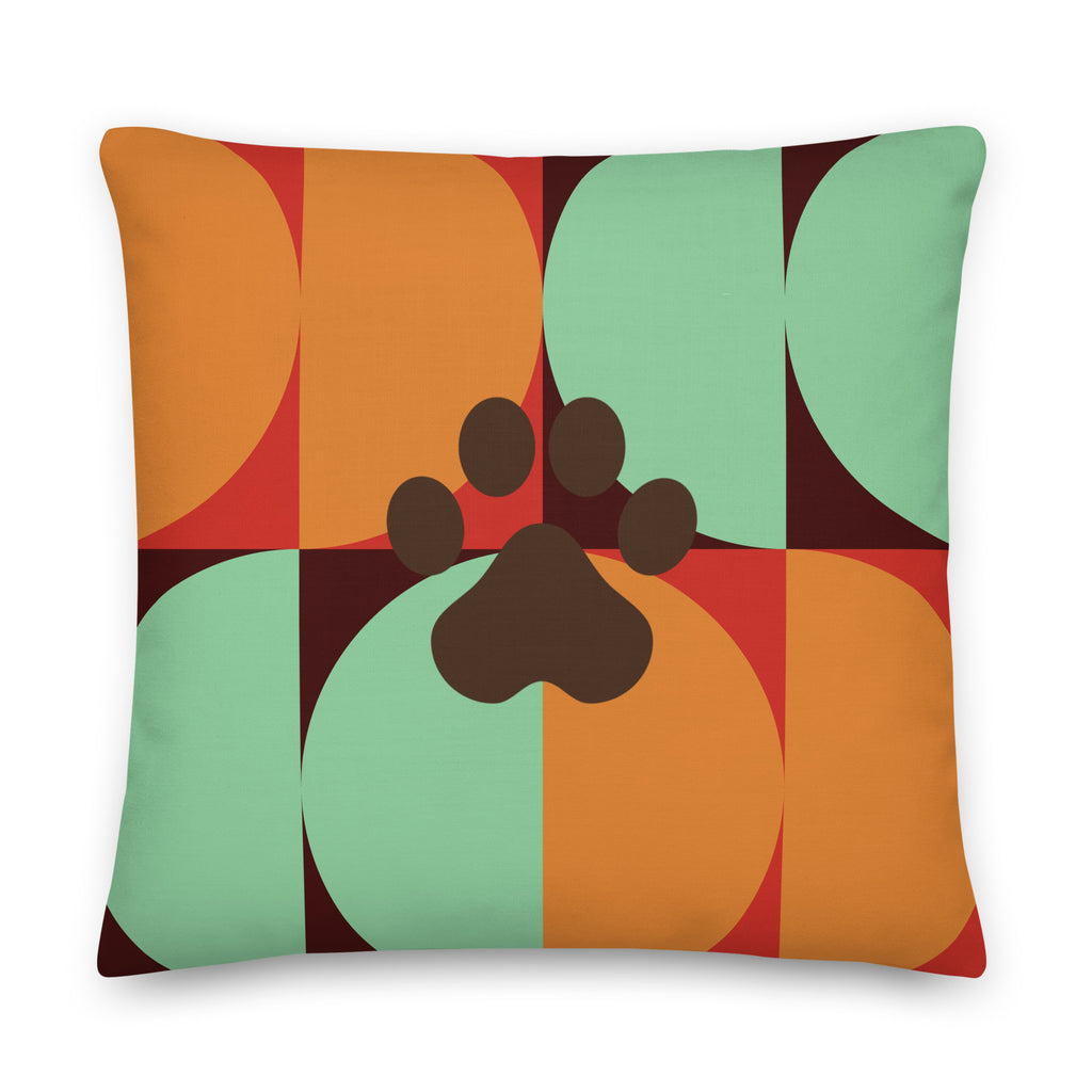 Multicolor retro-style pillow with bold geometric pattern in orange, teal, and red featuring a dark paw print in the center, Pets N’ Faith design
