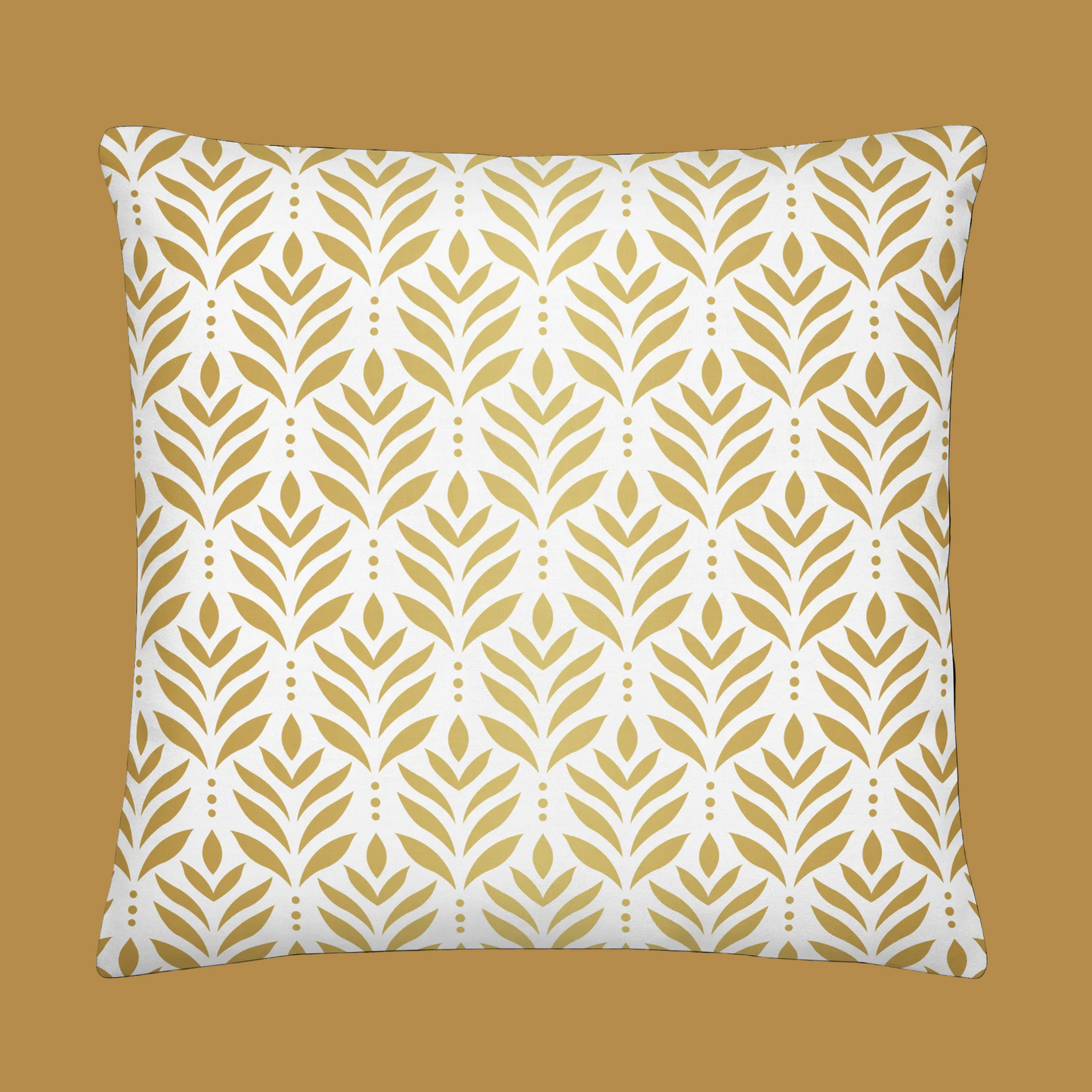 Decorative pillow with gold leaf pattern on a white background