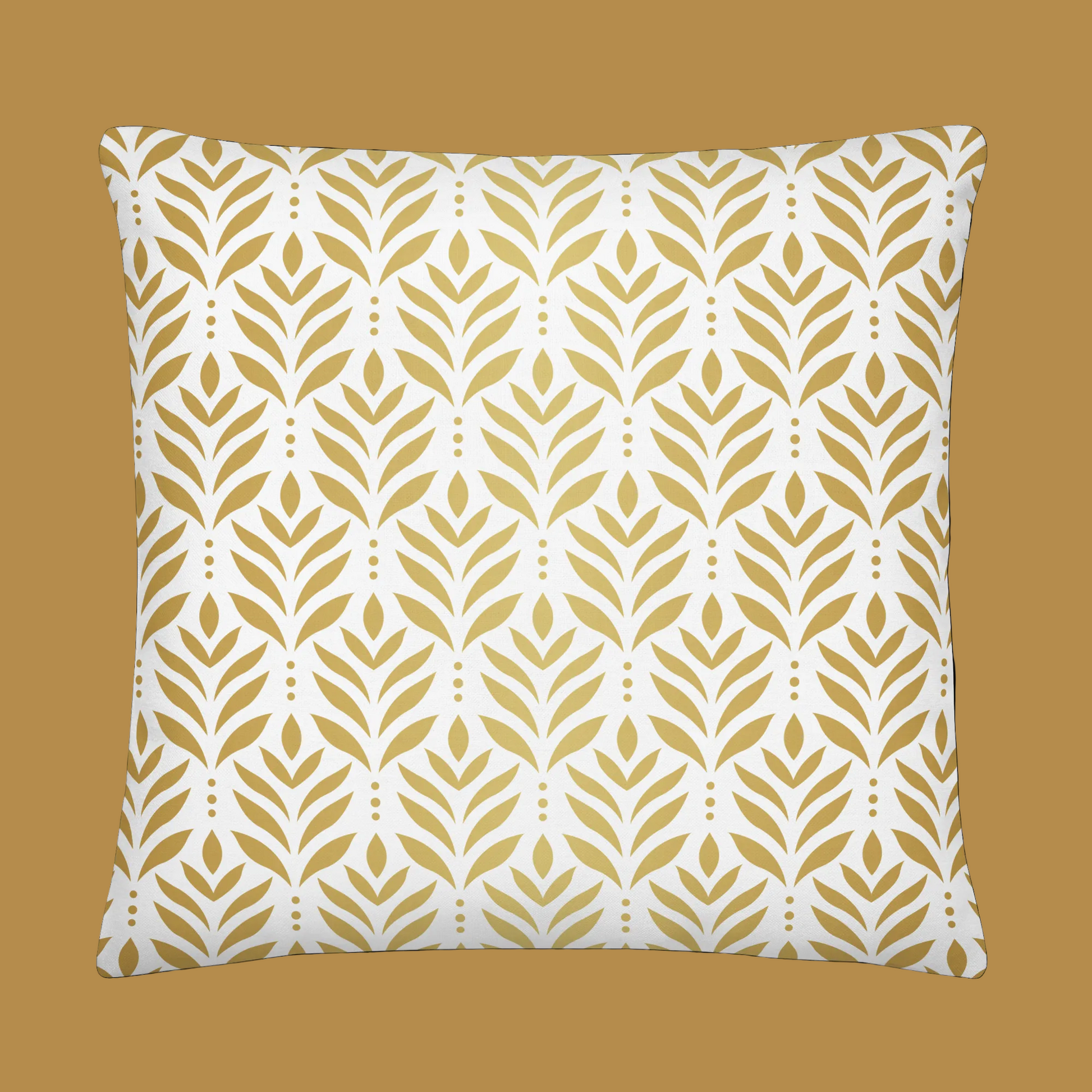 Decorative pillow with gold leaf pattern on a white background