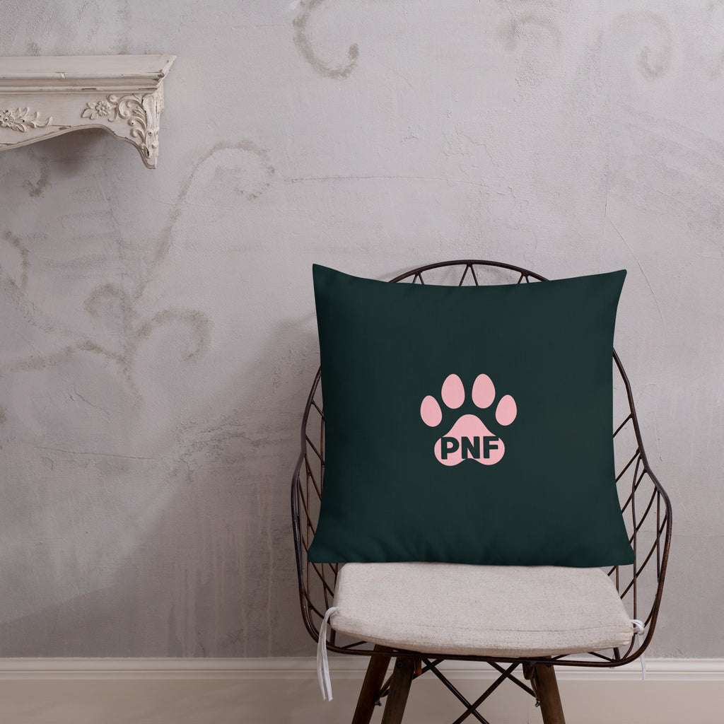 Back view of God's Little Helpers All Over Print Accent Pillow in forest green with pink accents showing the pink paw print on the back of the pillow